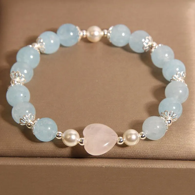 Natural aquamarine crystal bracelet with three shell pearls and lobster clasp on display