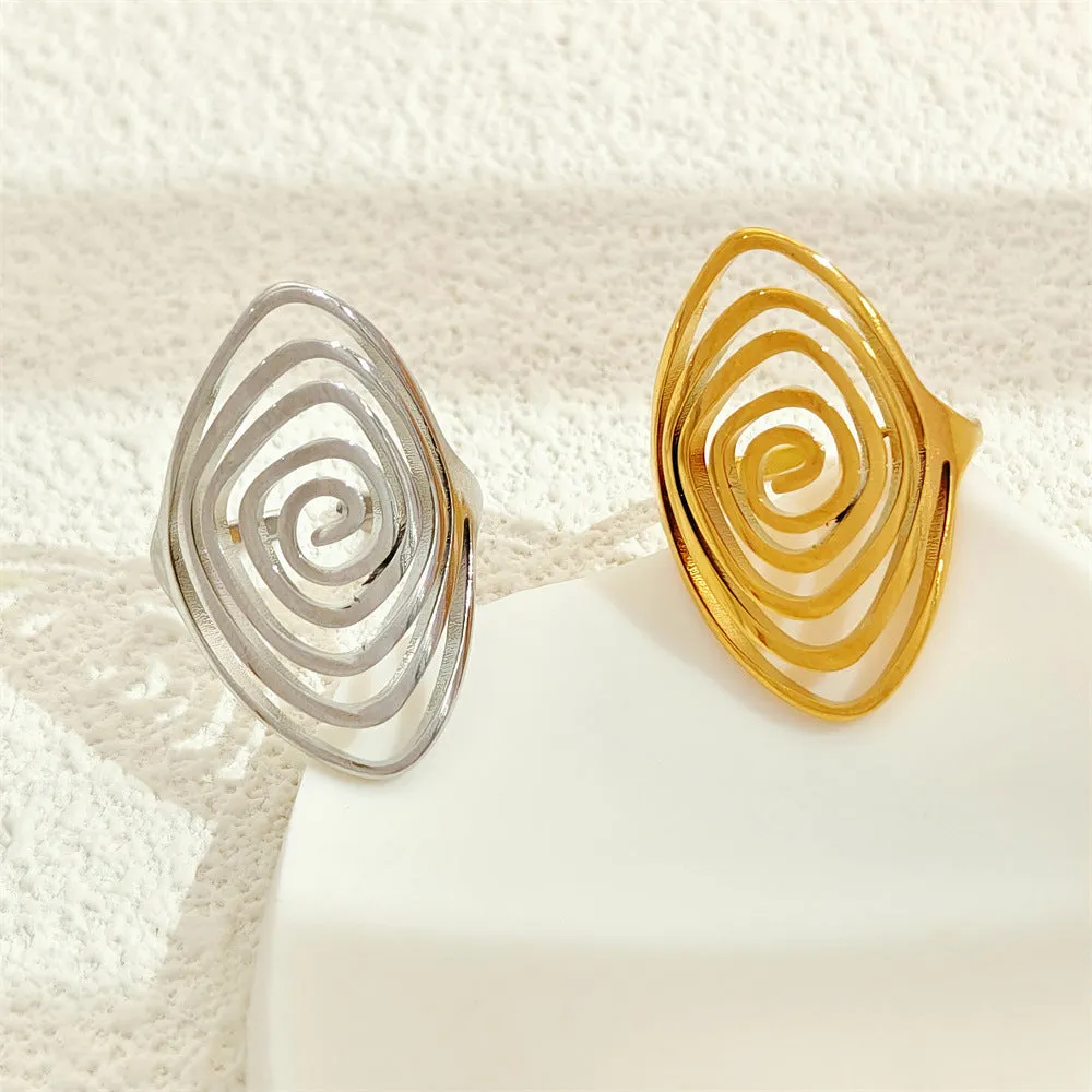 Gold electroplated stainless steel exaggerated circle ring with adjustable opening on a neutral background