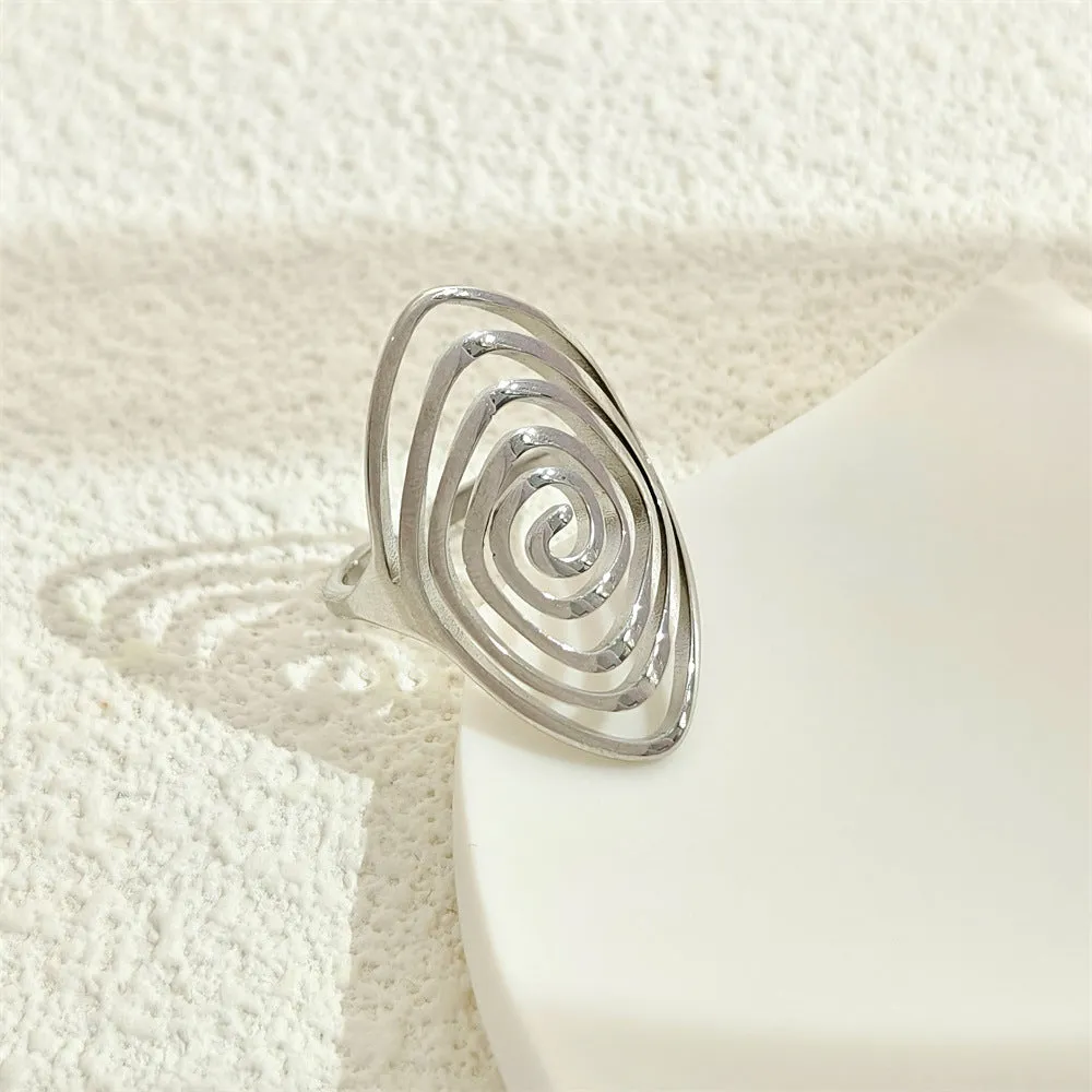 Gold electroplated stainless steel exaggerated circle ring with adjustable opening on a neutral background