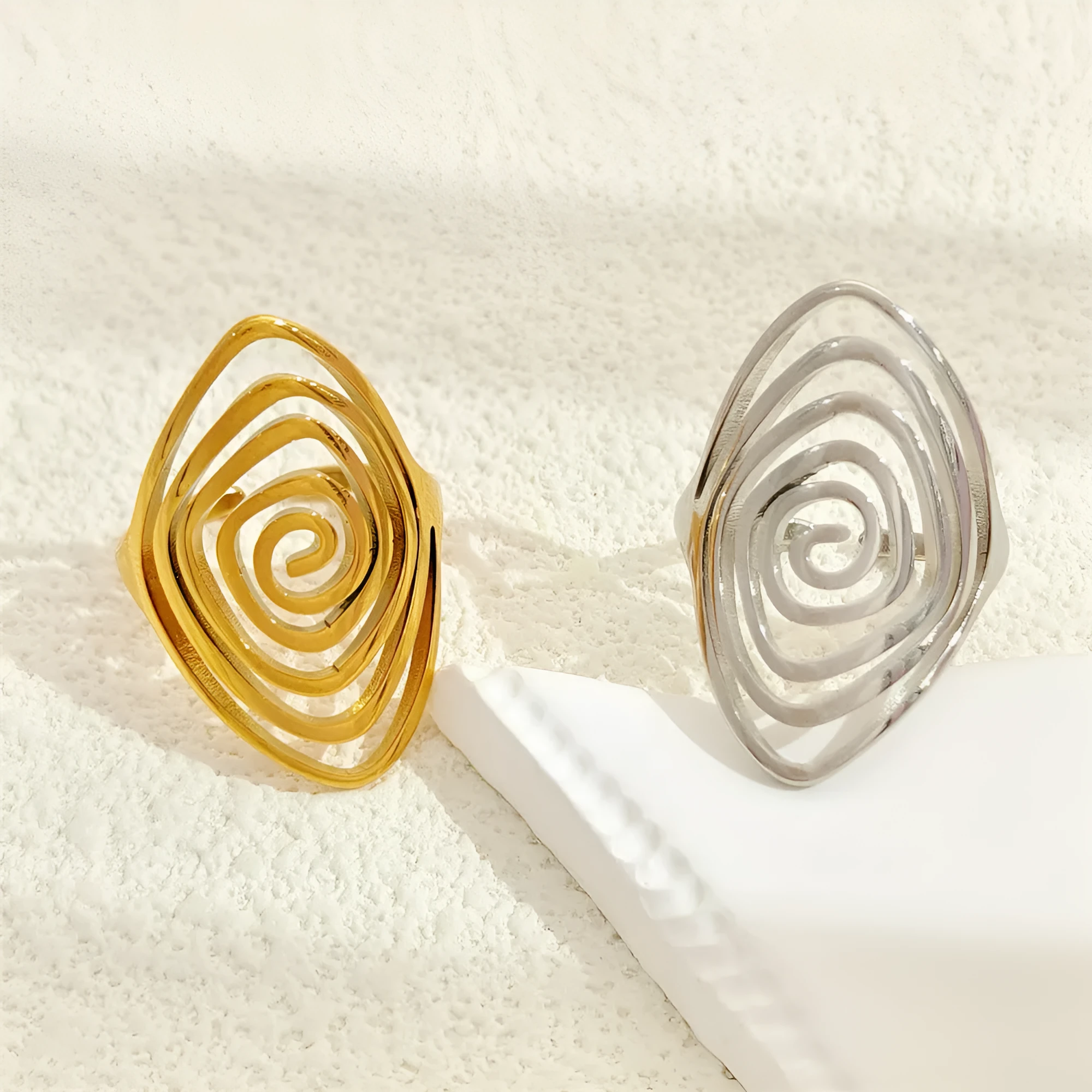 Gold electroplated stainless steel exaggerated circle ring with adjustable opening on a neutral background