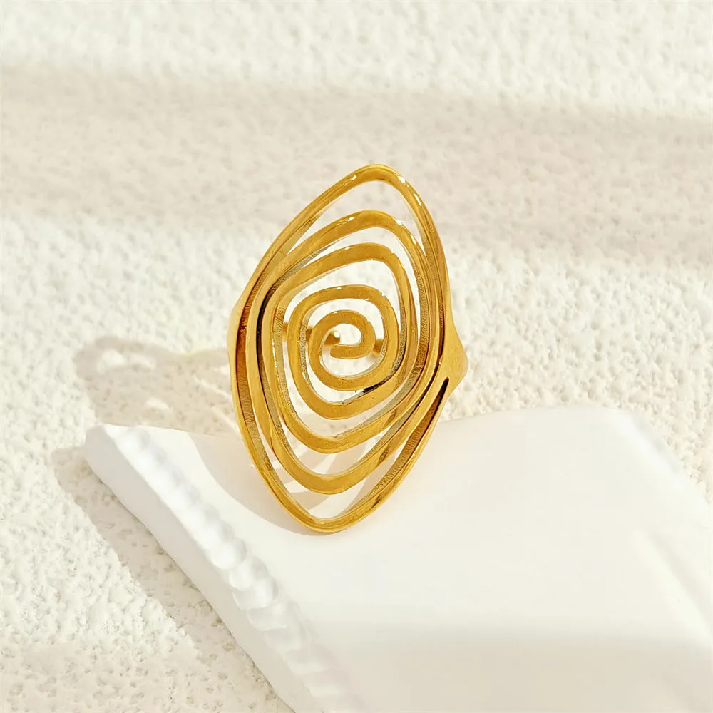 Gold electroplated stainless steel exaggerated circle ring with adjustable opening on a neutral background