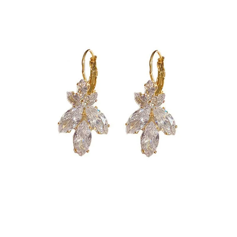 Women's platinum colour leaf earrings with inlaid zircon detailing on alloy background