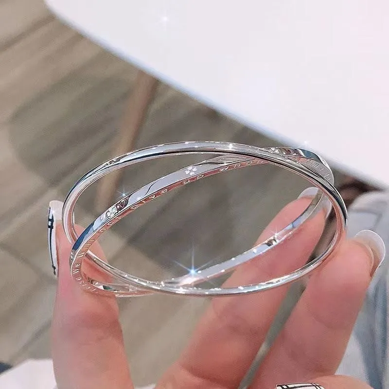 Women's silver-plated copper double ring bracelet on white background, geometric closed solid design, size 60mm