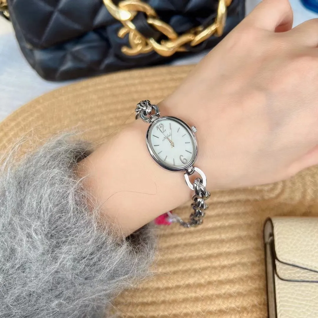Lady's steel strap quartz watch with oval hollow chain in gold case gold face design