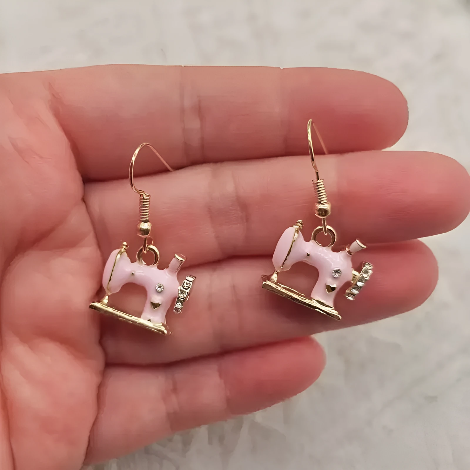 Pair of alloy vintage sewing machine earrings with oil drip finish in black colour
