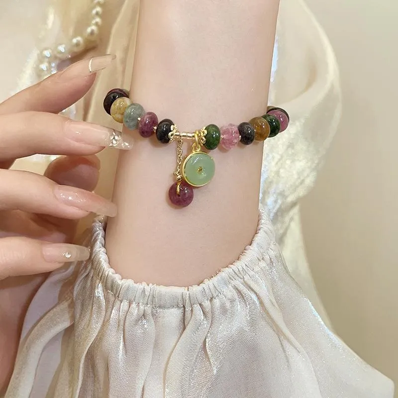 Colourful tourmaline bracelet with rabbit pendant and round abacus beads on wrist