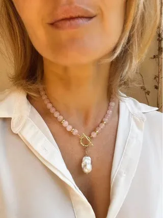 Women's handmade stainless steel pink crystal bracelet and necklace set, modern minimalist 10mm jewellery on a flat surface