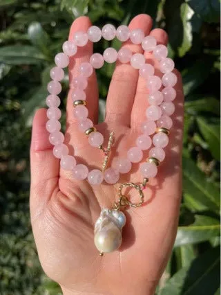 Women's handmade stainless steel pink crystal bracelet and necklace set, modern minimalist 10mm jewellery on a flat surface