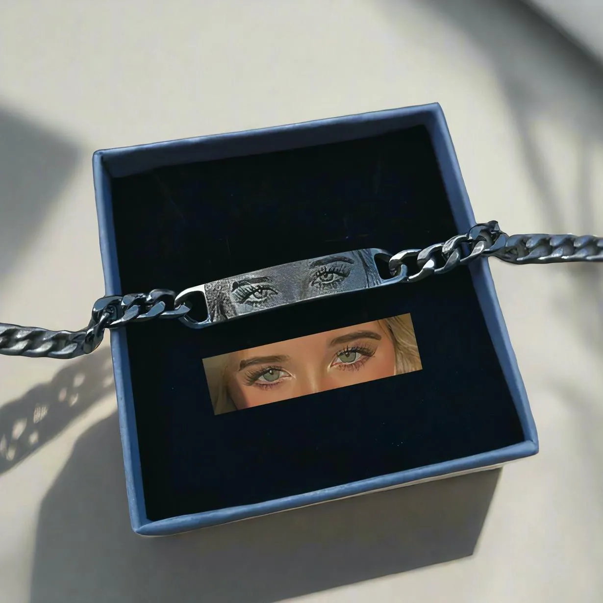 Personalised stainless steel bracelet with laser engraved human eye design, available in black, gold, and silver finishes
