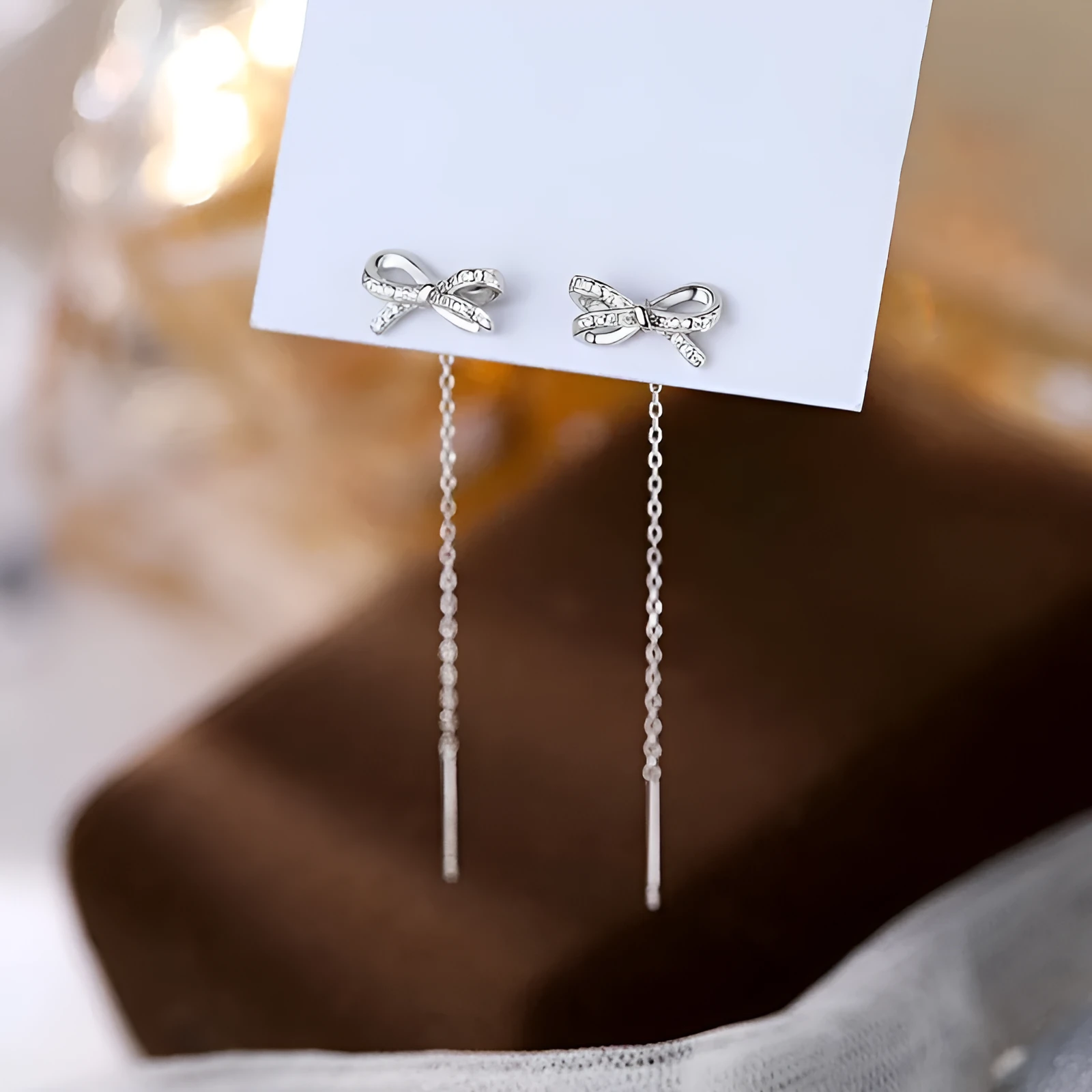 Women's white K bow earrings with long tassel ear thread, copper construction