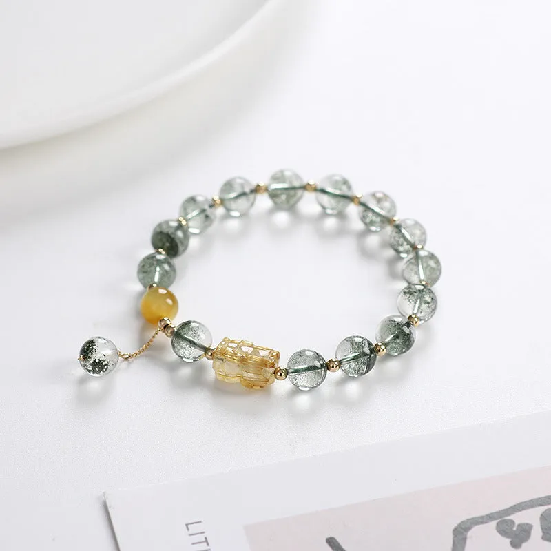 Green Phantom Quartz bracelet with gold rutile patterns in geometric 8mm beads