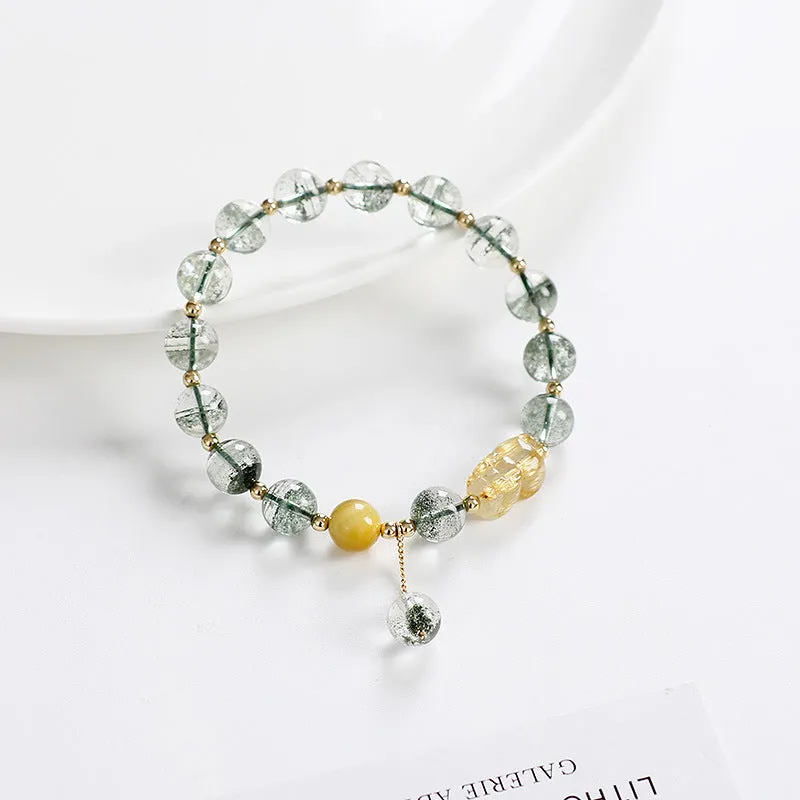 Green Phantom Quartz bracelet with gold rutile patterns in geometric 8mm beads