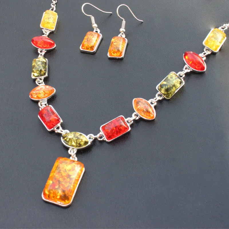 Two-piece jewellery set with alloy electroplated white pendant necklace and earrings featuring artificial gems.