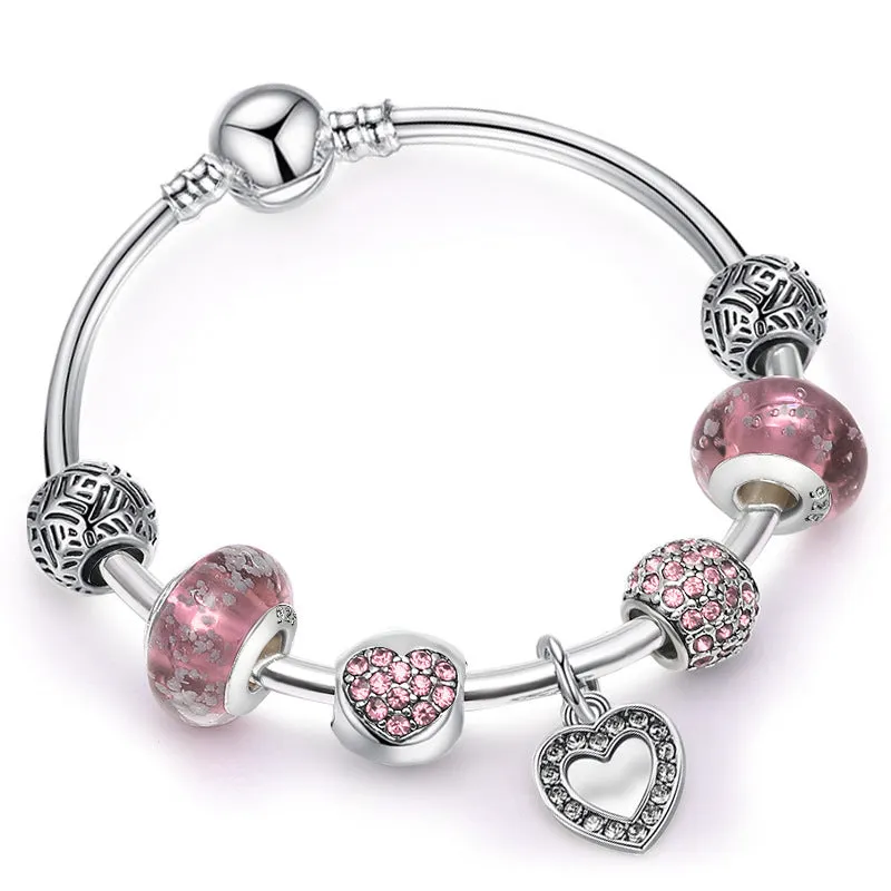 DIY beaded bracelet for women with love pendant in gold, rose gold, and silver colours on a light background