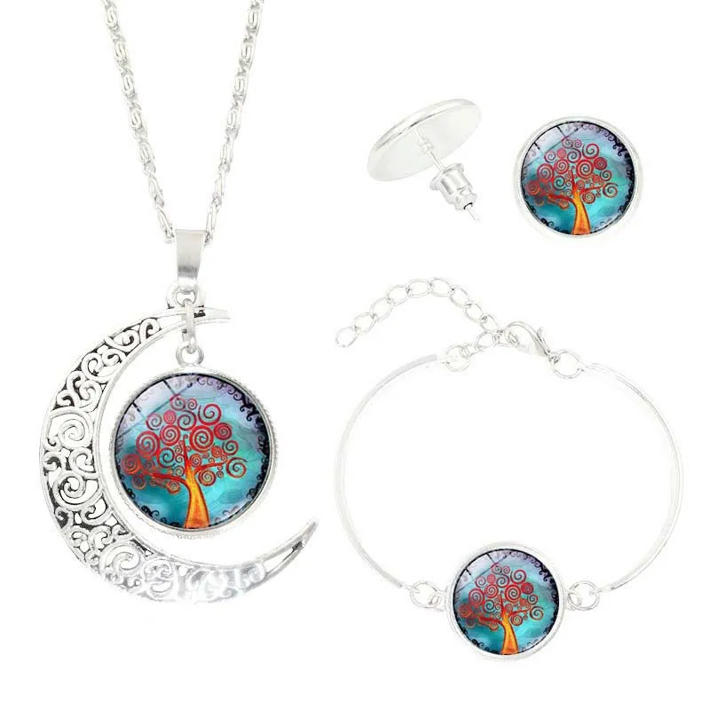 Tree of Life jewellery set with alloy and glass gem pendants: necklace, earrings, and bracelet on display