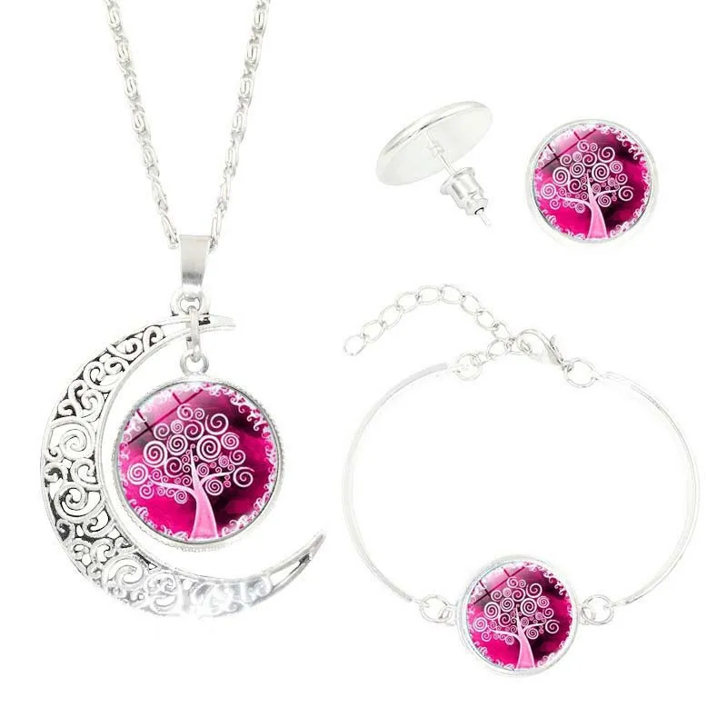 Tree of Life jewellery set with alloy and glass gem pendants: necklace, earrings, and bracelet on display