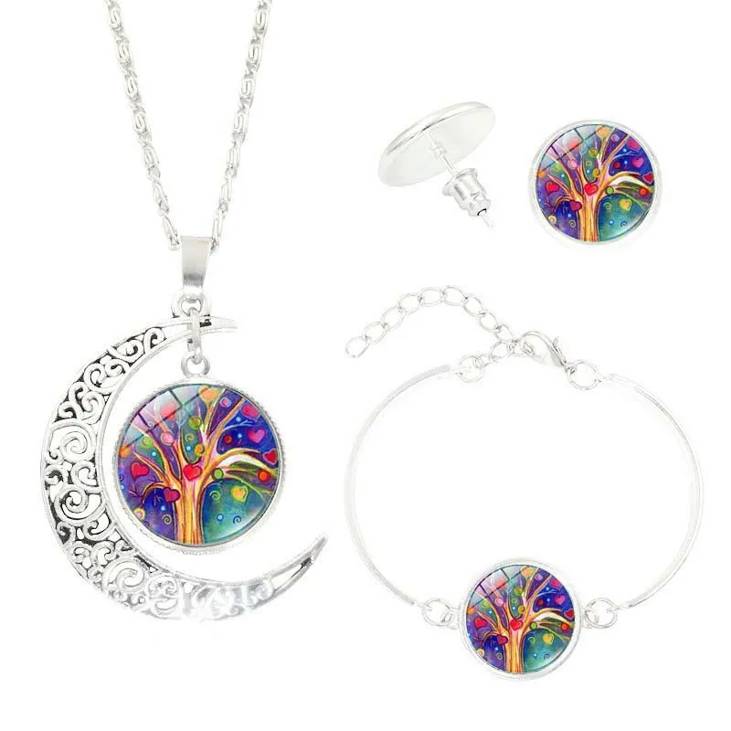 Tree of Life jewellery set with alloy and glass gem pendants: necklace, earrings, and bracelet on display