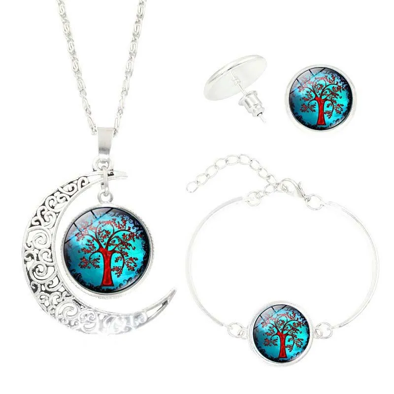 Tree of Life jewellery set with alloy and glass gem pendants: necklace, earrings, and bracelet on display