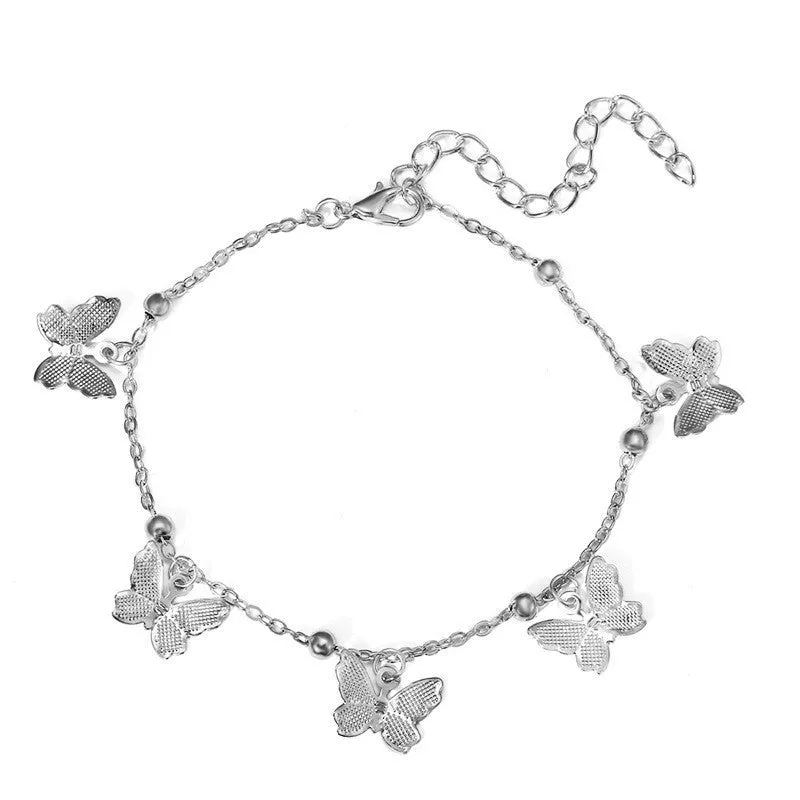 Alloy hollow butterfly design anklet in gold finish on a woman's ankle, beach foot ornament style
