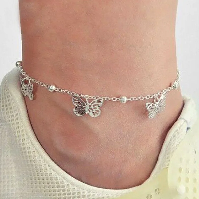 Alloy hollow butterfly design anklet in gold finish on a woman's ankle, beach foot ornament style