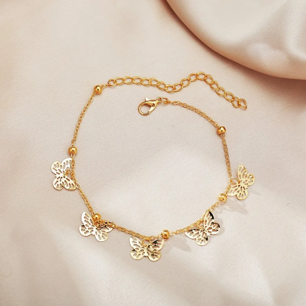 Alloy hollow butterfly design anklet in gold finish on a woman's ankle, beach foot ornament style