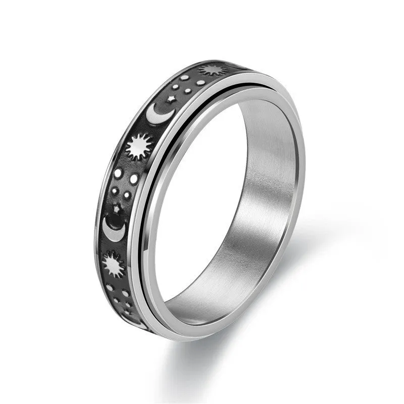 Stars And Moon geometric stainless steel rotatable ring in black star moon finish on a plain background