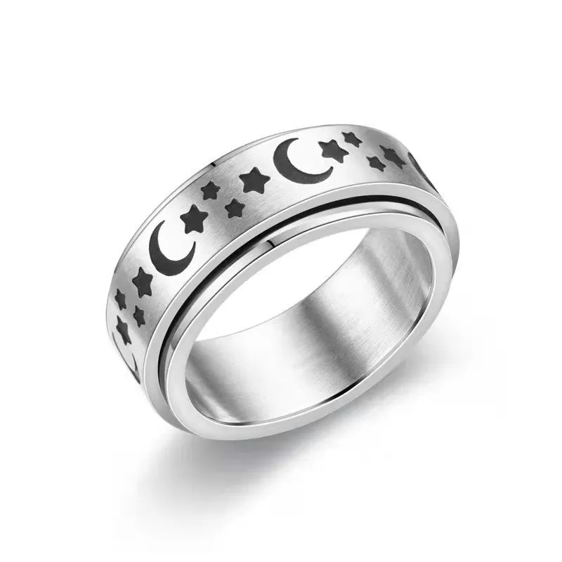 Stars And Moon geometric stainless steel rotatable ring in black star moon finish on a plain background