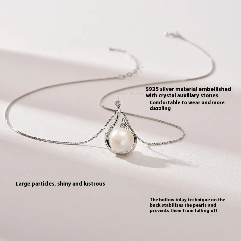 S925 silver necklace with natural freshwater pearl and geometric mother-of-pearl pendant on cross chain over a knitted sweater