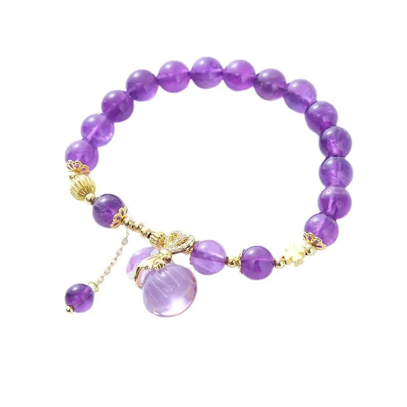 Purple amethyst crystal bracelet with money bag pendant and geometric peace buckle on wrist
