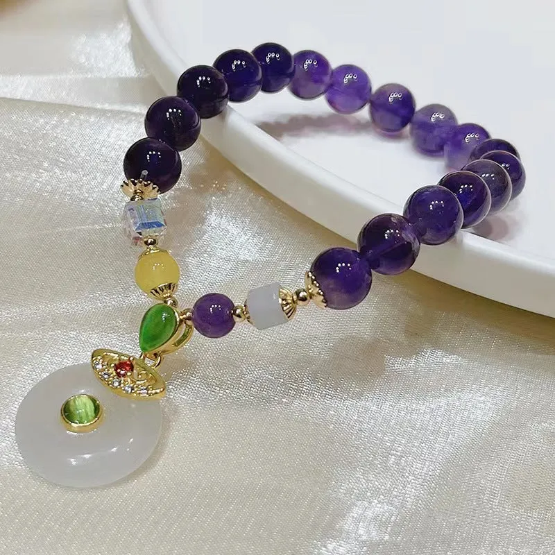 Purple amethyst crystal bracelet with money bag pendant and geometric peace buckle on wrist