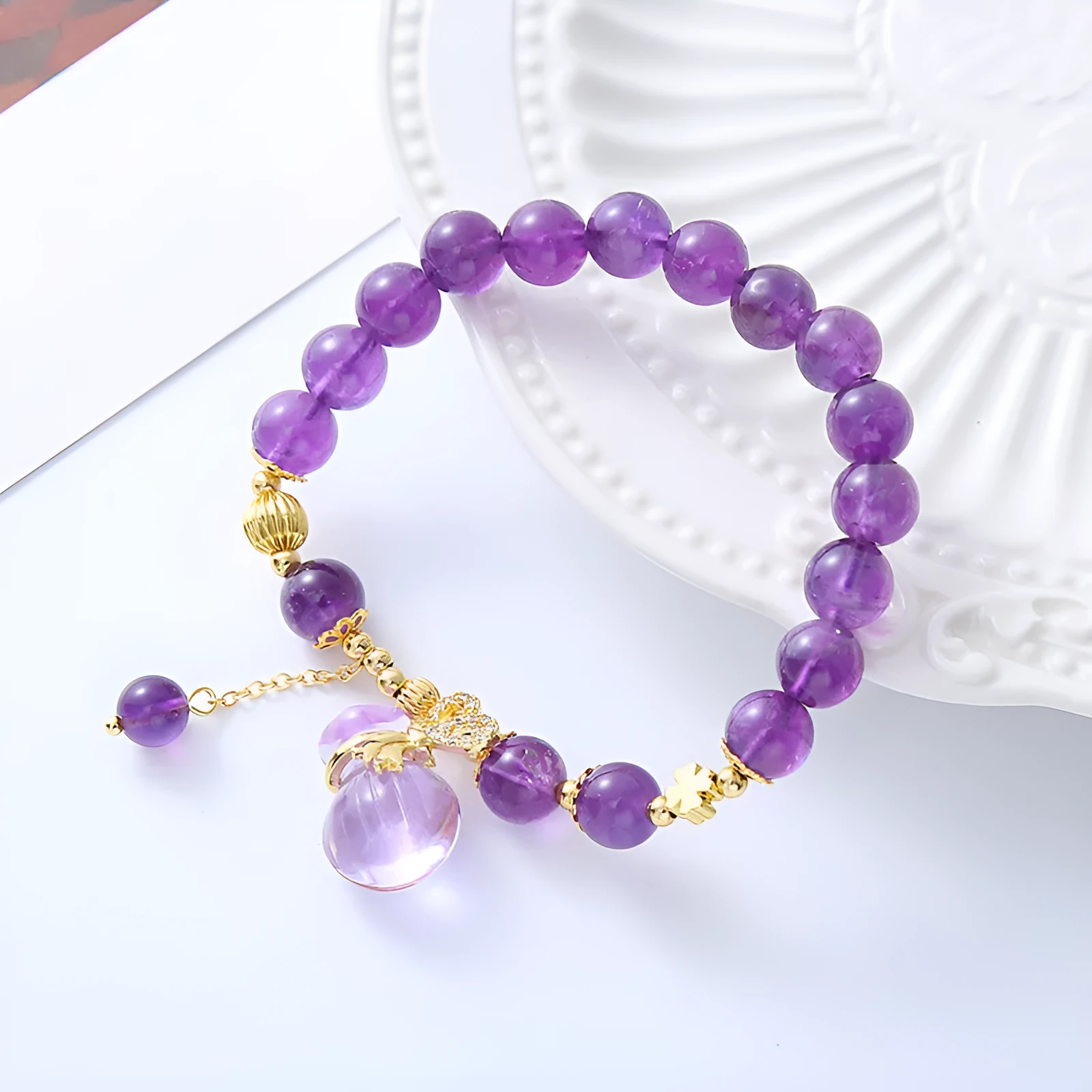 Purple amethyst crystal bracelet with money bag pendant and geometric peace buckle on wrist