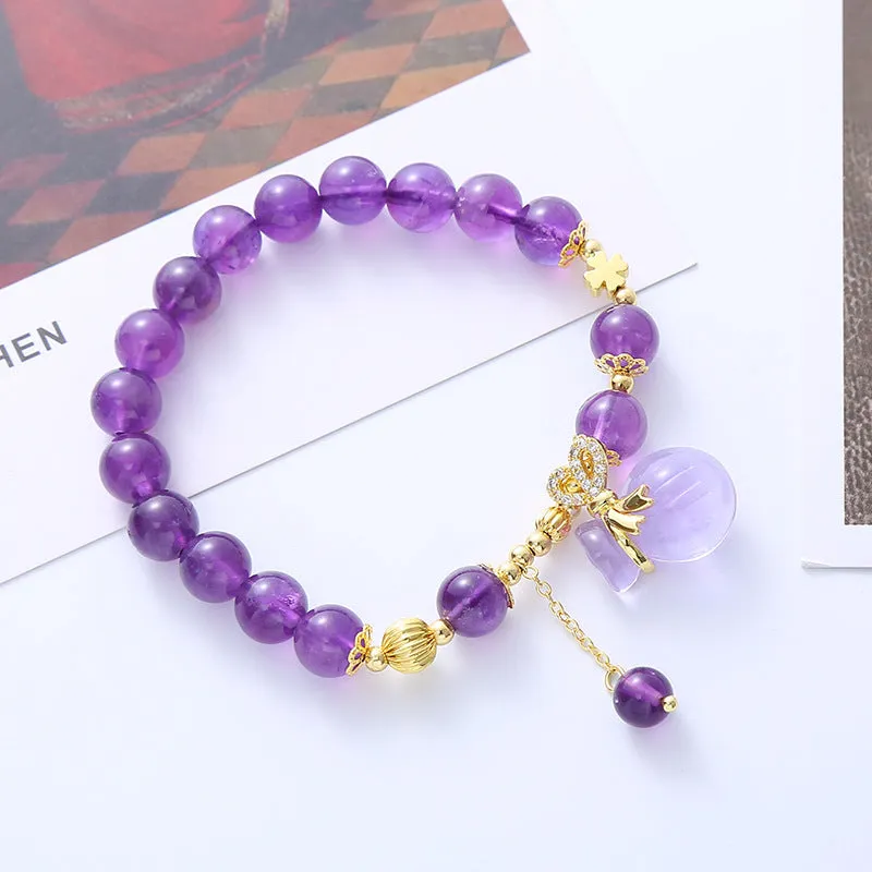 Purple amethyst crystal bracelet with money bag pendant and geometric peace buckle on wrist