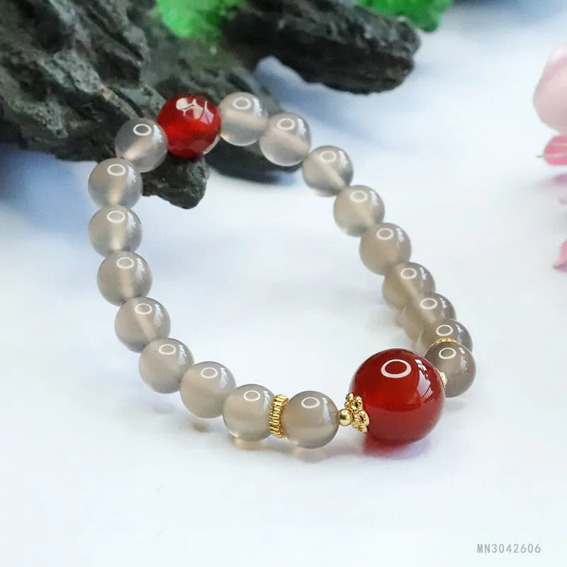 Smoky purple and red agate bracelet with 8mm geometric beads on a white background.