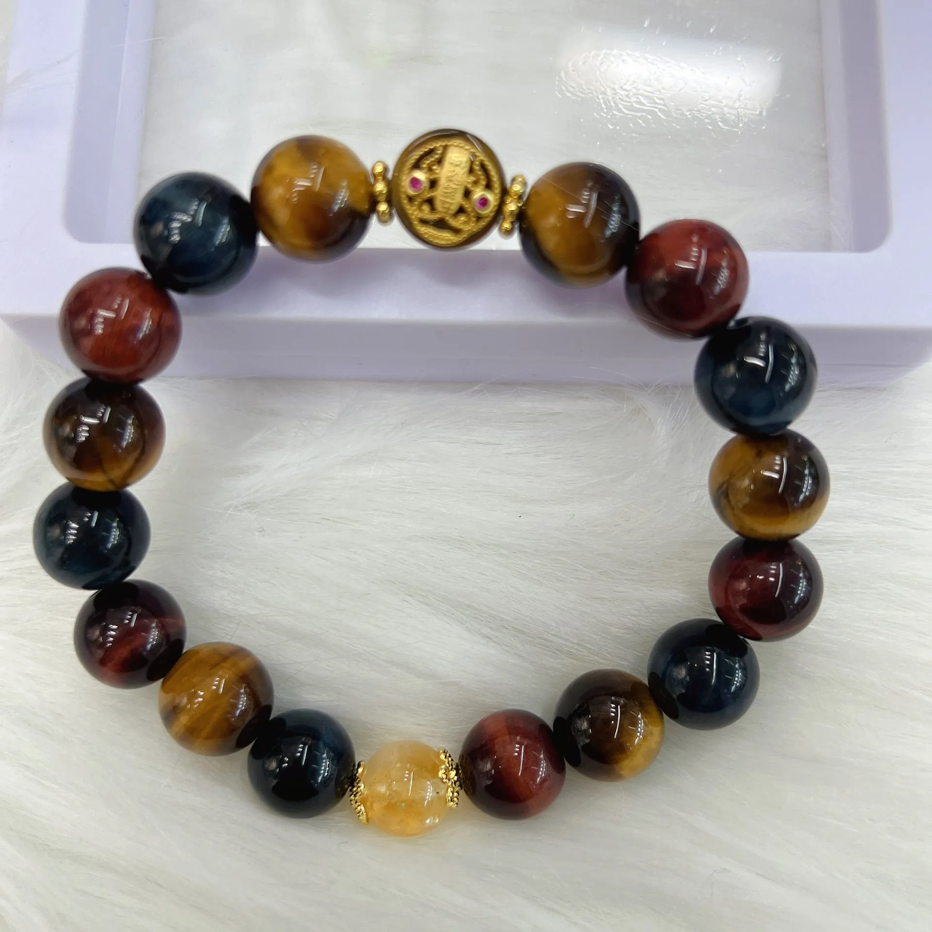 Natural golden-brown tiger eye gemstone bead bracelet with an adjustable clasp on a wrist.