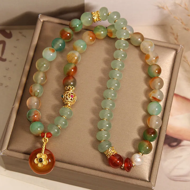 Women's peacock green agate double ring bracelet with safety buckle closure and rhinestone accents