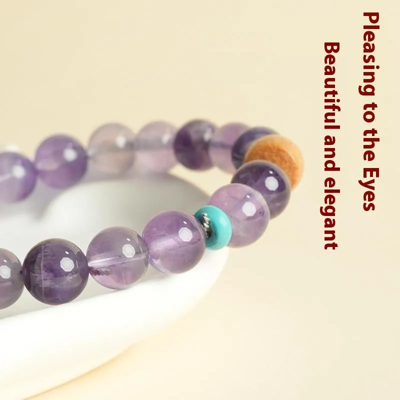 Handmade purple amethyst crystal bracelet for women on a wrist.