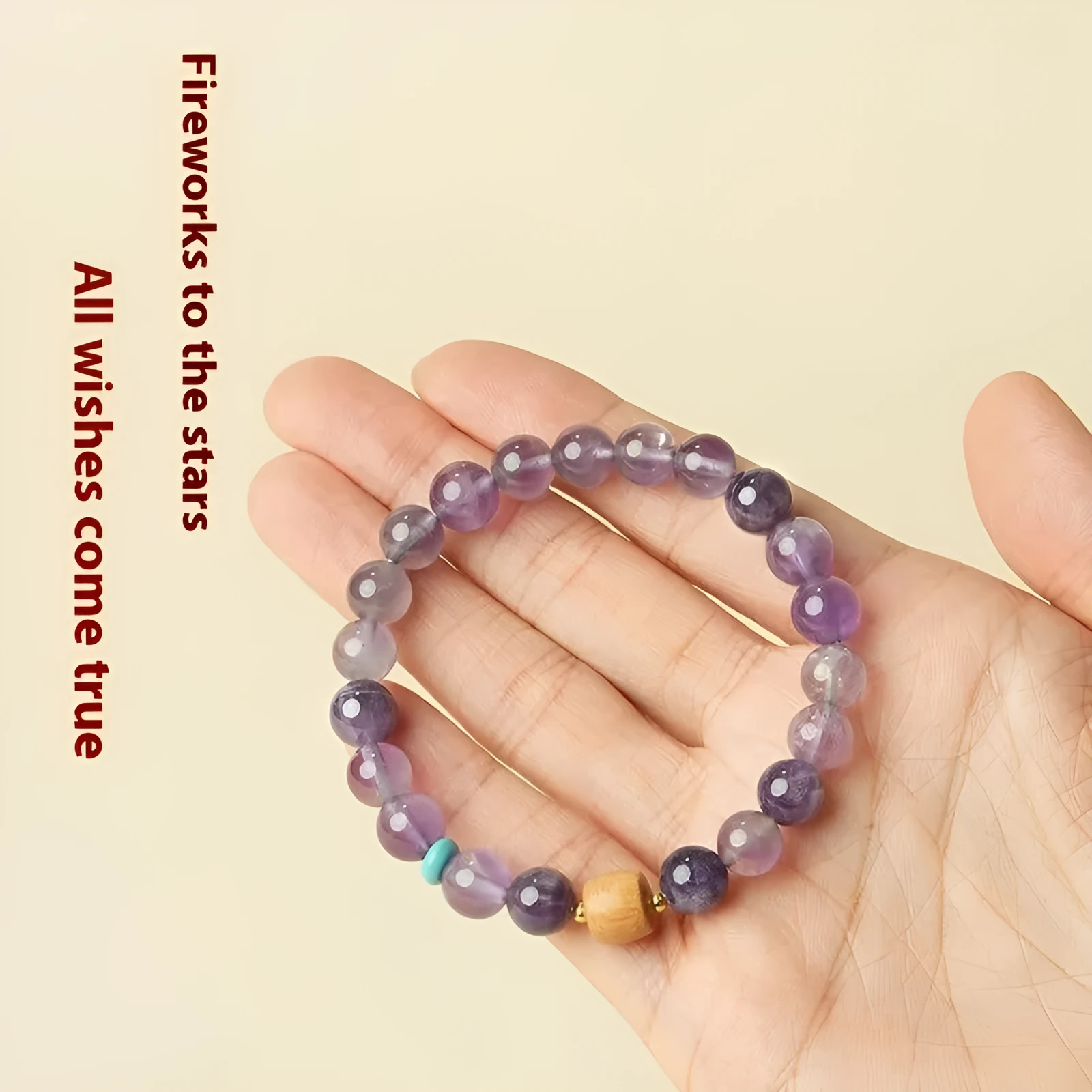 Handmade purple amethyst crystal bracelet for women on a wrist.
