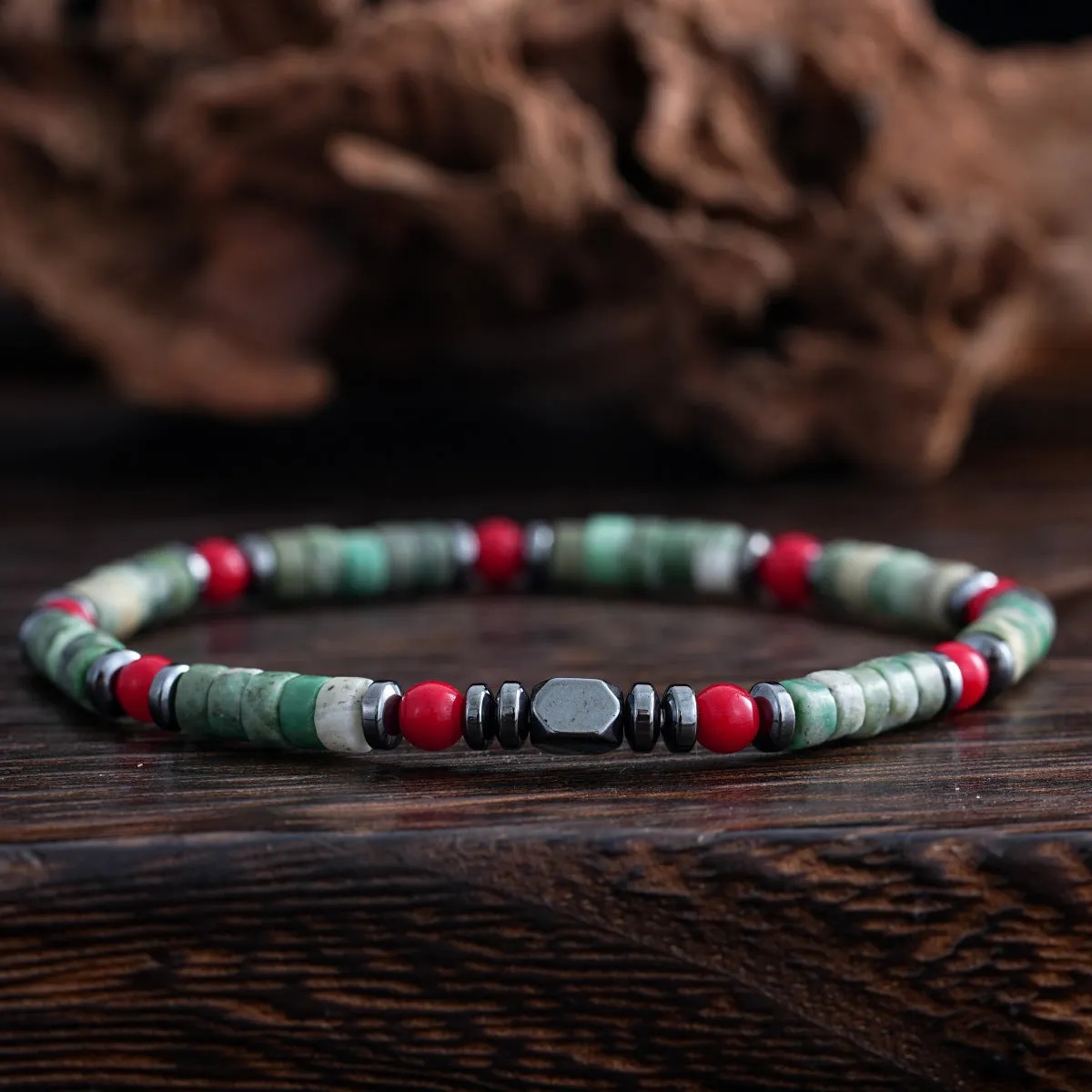Men's hand-woven bracelet with cylindrical semi-precious stone beads on a string.