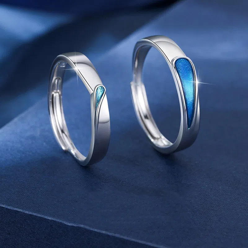 Blue tear drop copper ring with water drop shape and glue-drip finish on a dark background