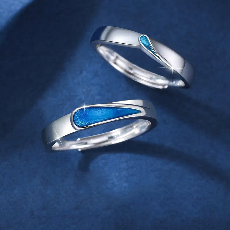 Blue tear drop copper ring with water drop shape and glue-drip finish on a dark background