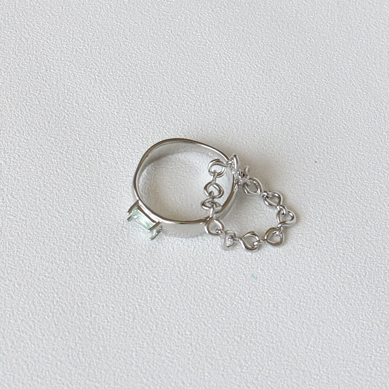 Copper platinum plated couple ring with three-ring gem design in style A on a neutral background