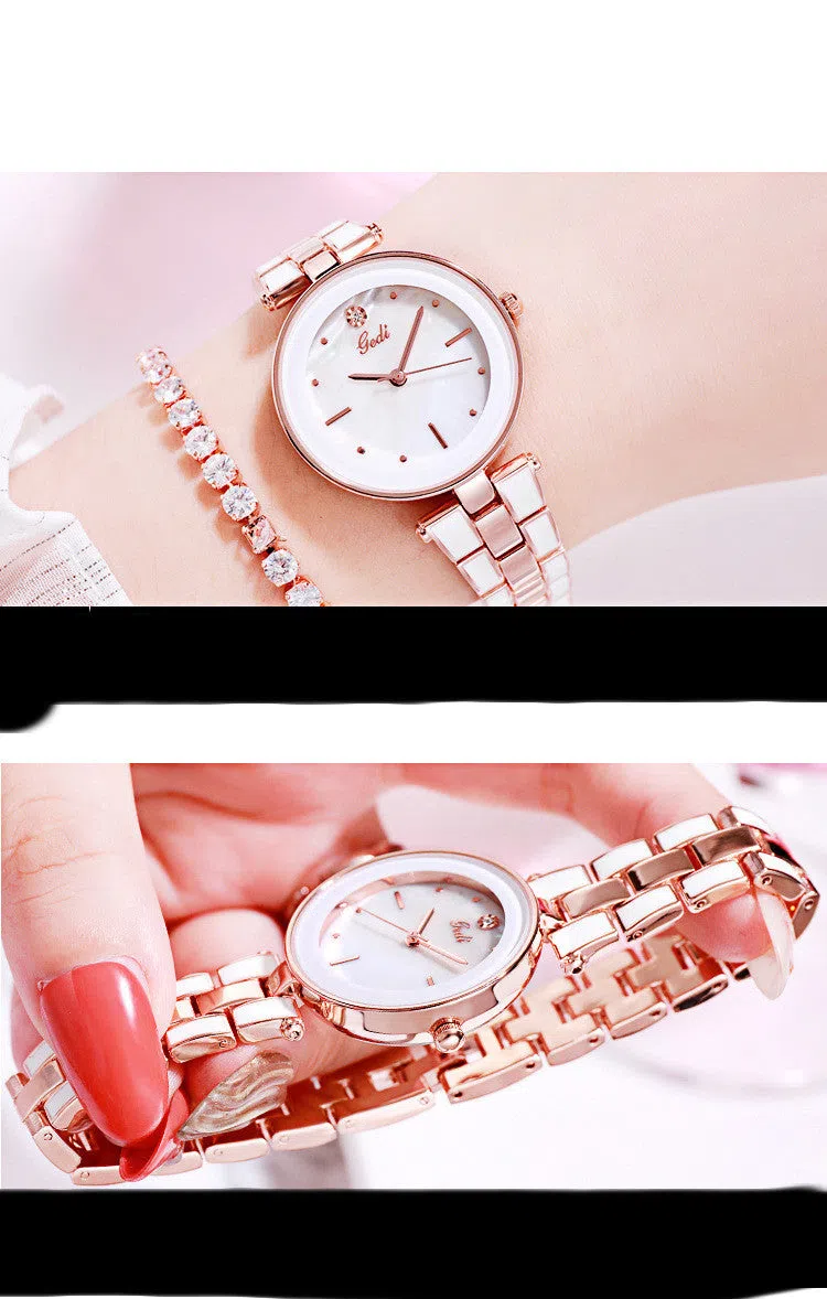 White dial ladies quartz watch with rose gold accents, steel strap, 30mm round alloy case on flat surface
