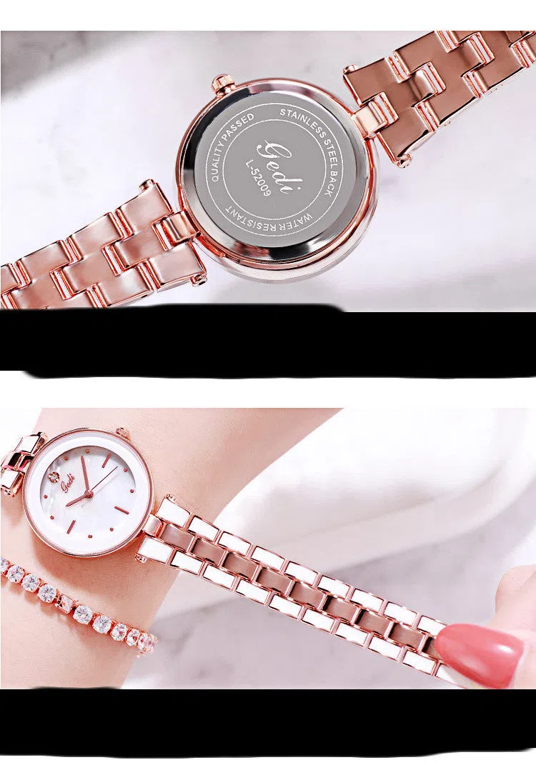 White dial ladies quartz watch with rose gold accents, steel strap, 30mm round alloy case on flat surface