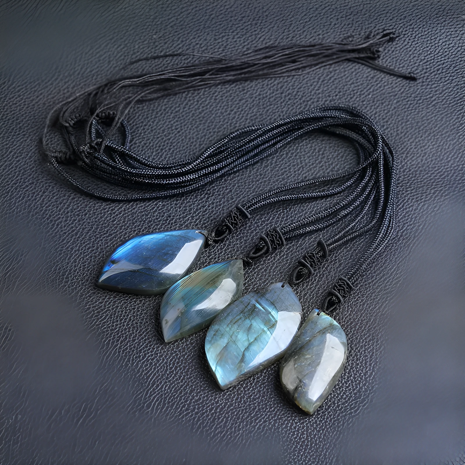 Natural labradorite leaf pendant necklace with blue moonlight effect on white background