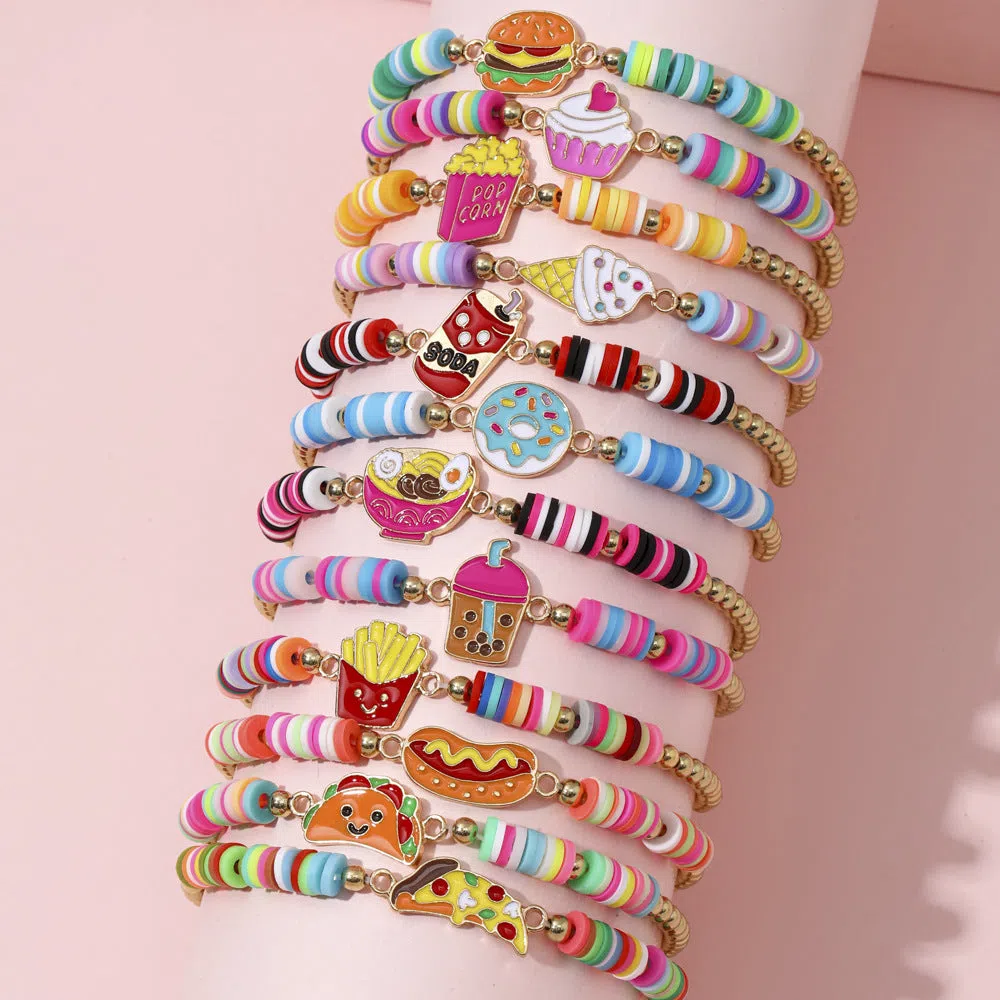 Children's polymer clay bracelet with dinosaur bead theme on a white background