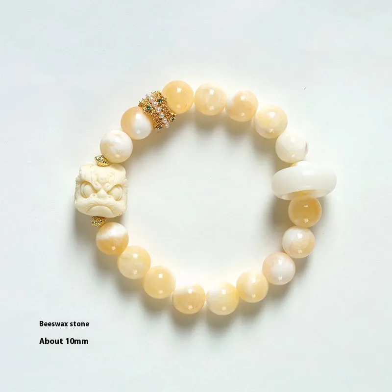 Hand-woven bracelet with large round grey agate and mellite beads on wrist.