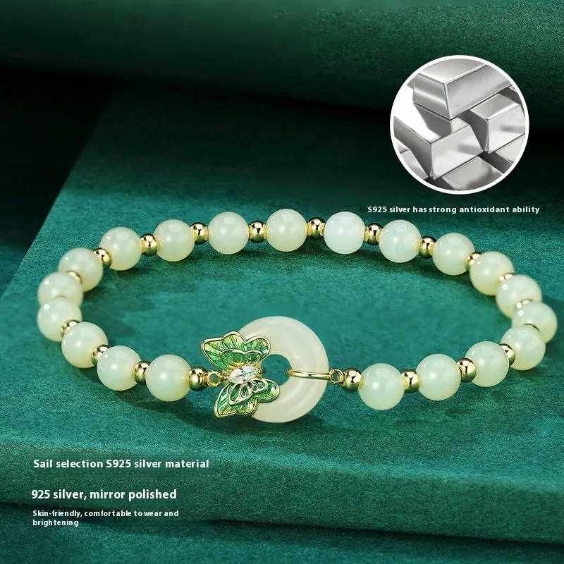 Cyan Hetian jade bracelet with sterling silver butterfly design and gemstone inlays on wrist