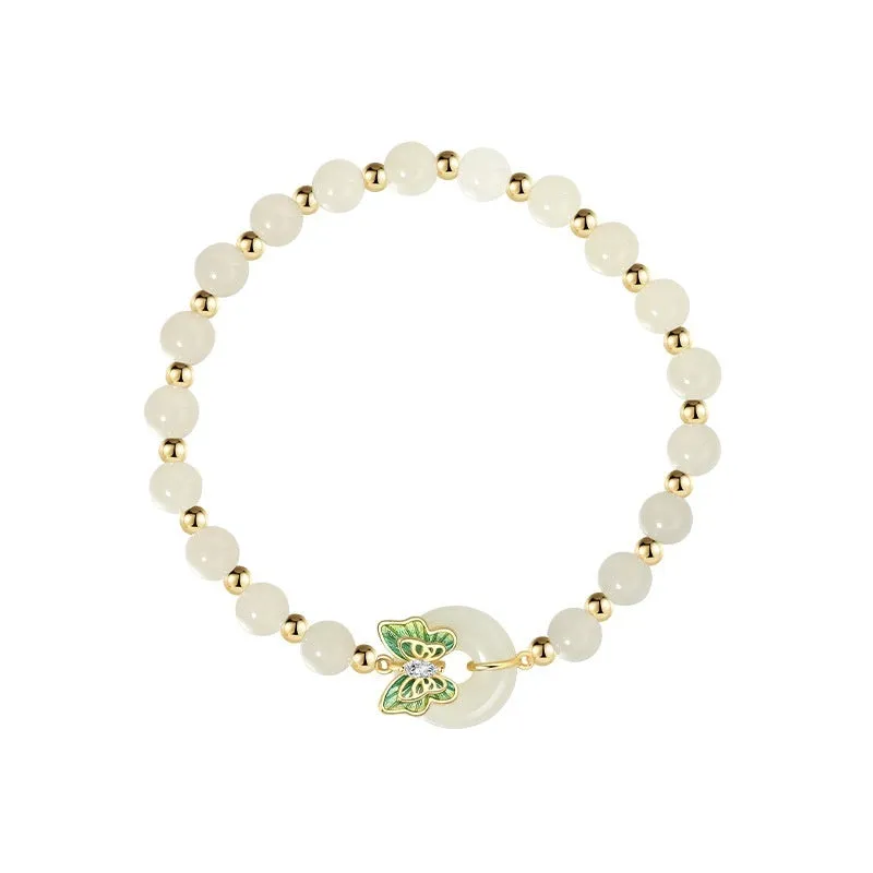 Cyan Hetian jade bracelet with sterling silver butterfly design and gemstone inlays on wrist