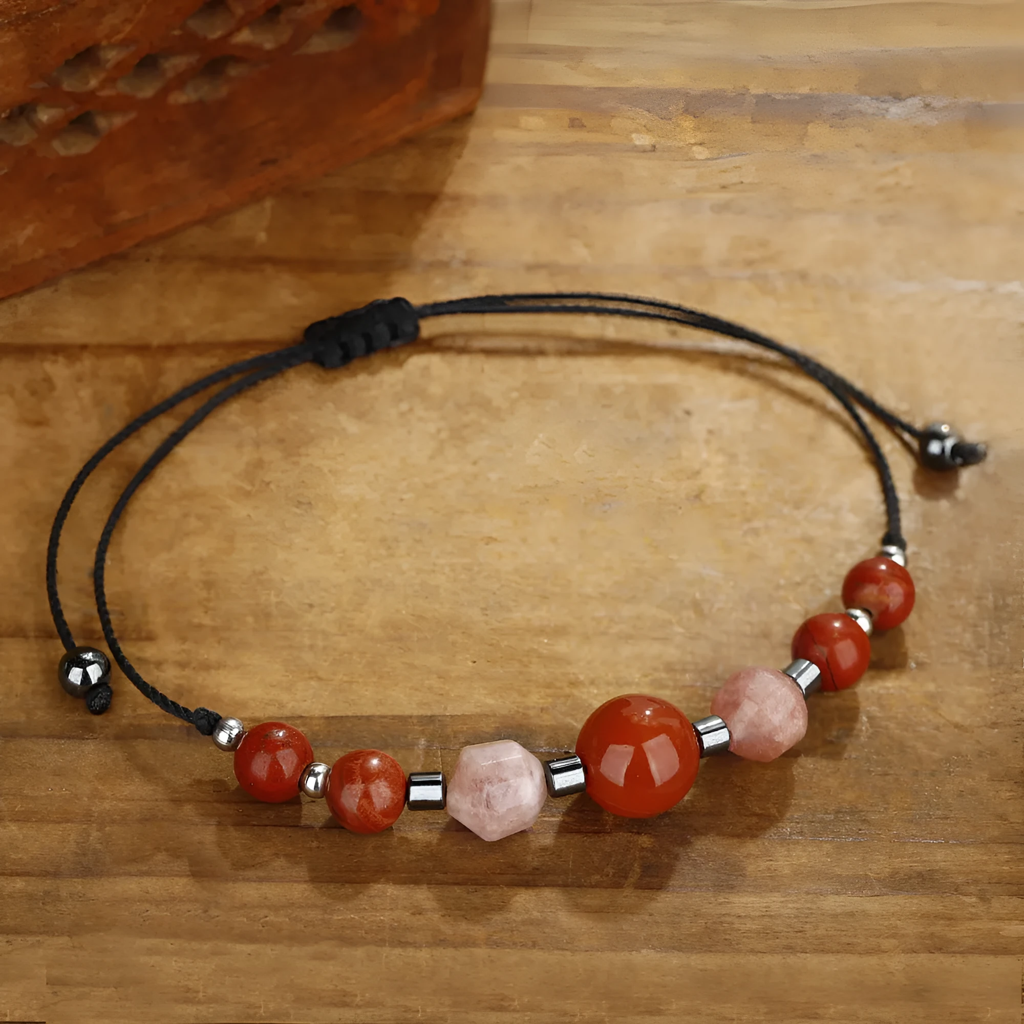 Handmade red geometric bracelet with sunstone, redstone, and copper beads.