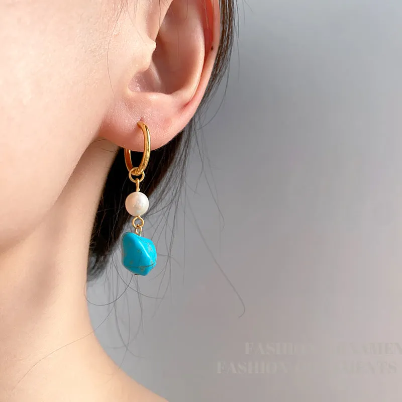 A pair of geometric copper ear clips with irregular turquoise stone and cultured pearls, showing both short and dangle styles.